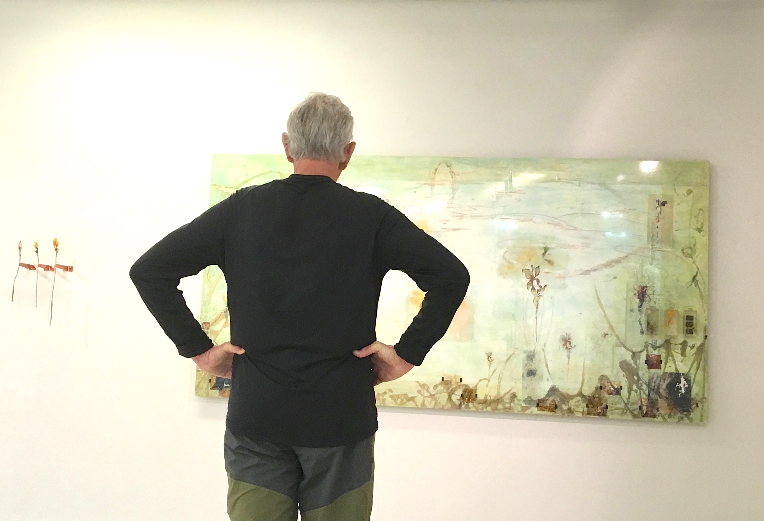 man looking a at artwork in gallery