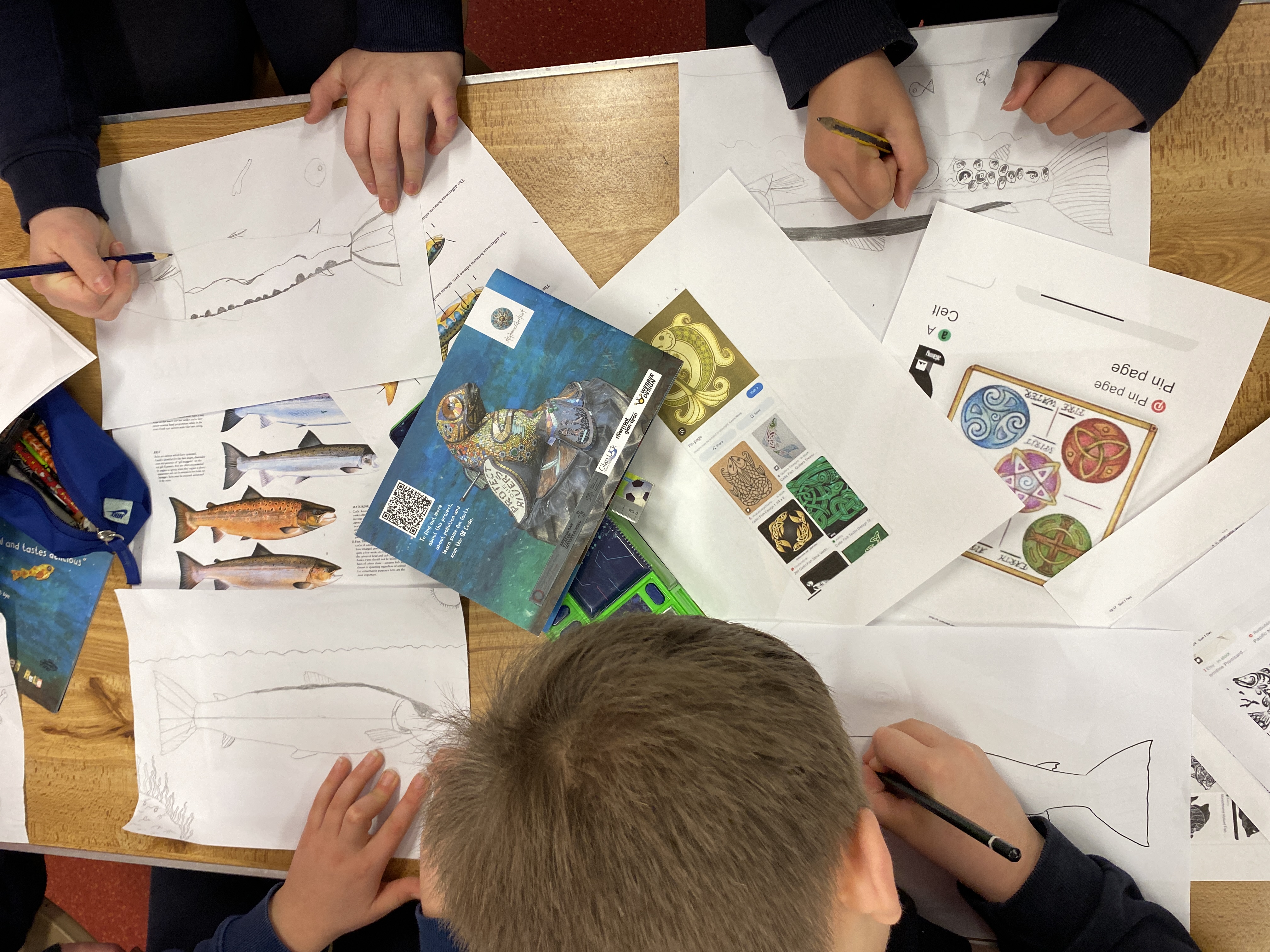 Children designing a mosaic salmon