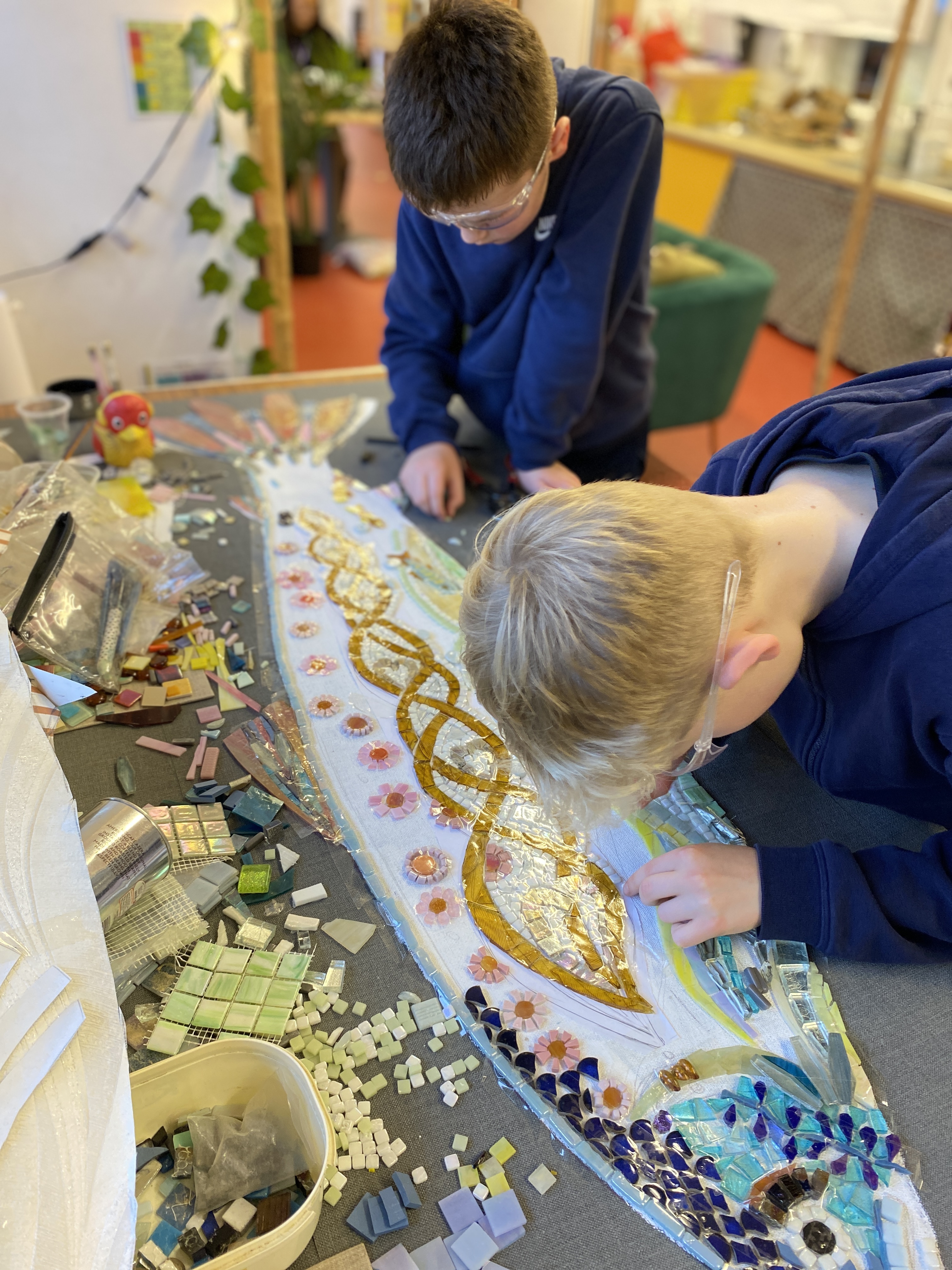 making a mosaic salmon with school children